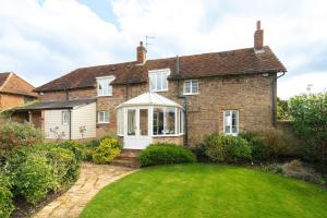 an old brick house with a lawn in front of it at Charming 4 Bed Cottage in Herts Countryside - Pass the Keys 