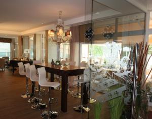 a dining room with a table and chairs at Seehotel Europa Resort in Velden am Wörthersee +64 photos