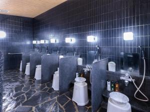 a bathroom with a bunch of toilets in a room at APA Hotel Keisei Narita Ekimae in Narita