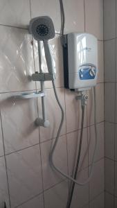 a hair dryer and a blow dryer in a bathroom at Mini Lookout Entebbe in Entebbe