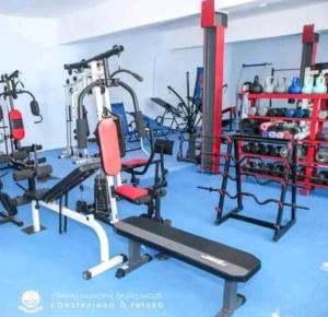 a gym with several tread machines in a room at Kaza Mamai di Fora, o conforto da sua estadia in Calheta de São Miguel
