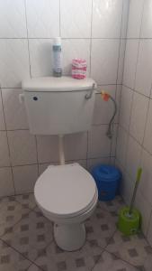 a bathroom with a white toilet in a room at Mini Lookout Entebbe in Entebbe