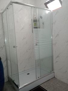 box doccia con porta in vetro in una stanza di Kaza Mamai di Fora, o conforto da sua estadia a Calheta