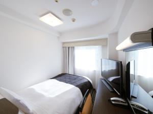 Posteľ alebo postele v izbe v ubytovaní APA Hotel Keisei Narita Ekimae