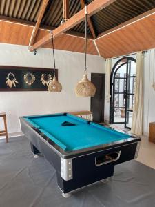 a pool table in the middle of a room at Villa Padi Pakem in Pakem