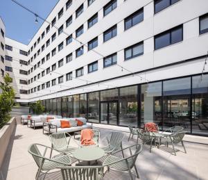 an outdoor patio with tables and chairs in front of a building at AMRO PAMPLONA Residencia de estudiantes in Pamplona
