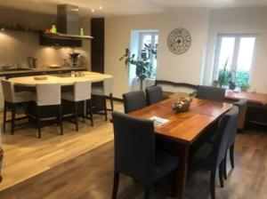 a kitchen and dining room with a wooden table and chairs at Villa de 3 chambres avec piscine privee jardin clos et wifi a Gaillac in Gaillac