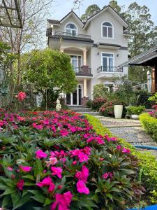 a house with pink flowers in front of it at Twin Villa Village Đà Lạt in Da Lat