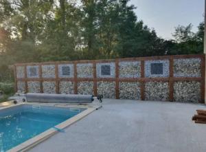 a fence with a swimming pool in a backyard at Villa de 3 chambres avec piscine privee jardin clos et wifi a Gaillac in Gaillac