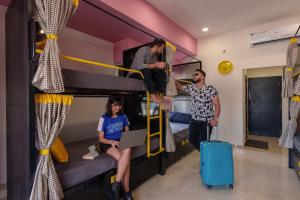 a group of people in a room with a bunk bed at The Hosteller Jaipur, MI Road in Jaipur