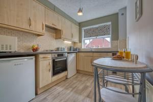 a kitchen with a table and a counter top at Stylish 2 Bed Flat Close To Nec Bhx in Solihull