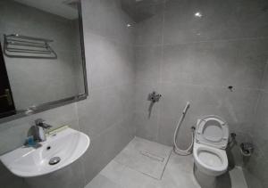 a bathroom with a toilet and a sink at Jeddah Grand Beach in Jeddah