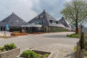 una fila de casas con una entrada delante en Appartement - Paviljoenwei 4 - Sneek (Offingawier) 'Havenzicht', en Offingawier