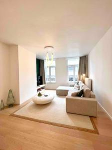 a living room with a couch and a table at Duplex chic et spacieux - Hypercentre in Liège