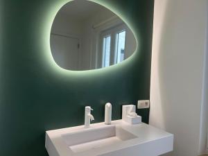 a bathroom with a white sink and a mirror at Duplex chic et spacieux - Hypercentre in Liège +31 photos
