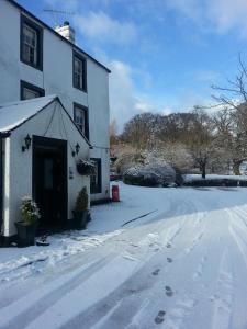 a house with snow on the ground in front of it at Royal Hotel in Dockray