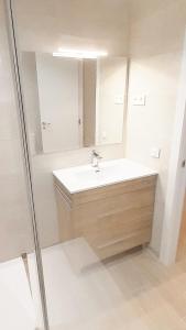 a bathroom with a sink and a mirror at Tarragonaapartments Prim 350 in Reus