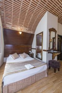 a bedroom with a large bed with a wooden ceiling at Naz Wooden House Inn in Istanbul