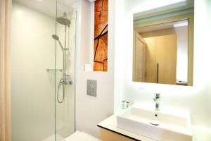 a bathroom with a sink and a shower at Hotel Orle in Gdańsk
