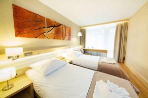 Postel nebo postele na pokoji v ubytování Hotel Orle