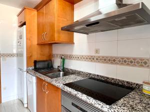 a kitchen with a sink and a stove at Dúplex el Torrent in Sort