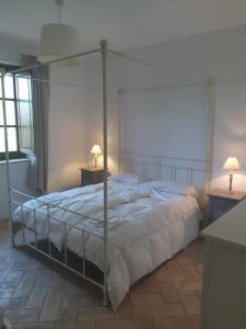 a bedroom with a bed and two tables and two lamps at Agriturismo Tenute di Hera - Via Francigena in Acquapendente