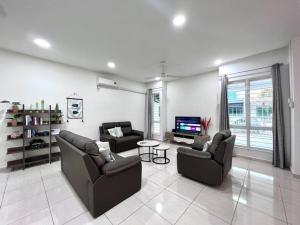 a living room with two couches and a tv at 4Bedroom Simfoni Langkawi Homestay in Kuah