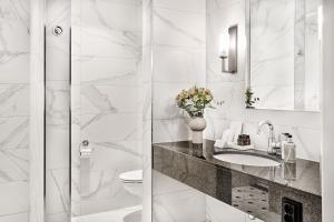 a white bathroom with a sink and a toilet at Opus XVI, a member of Small Luxury Hotels of The World in Bergen