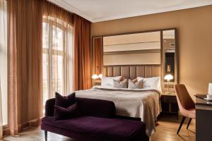 a hotel room with a bed and a chair at Opus XVI, a member of Small Luxury Hotels of The World in Bergen