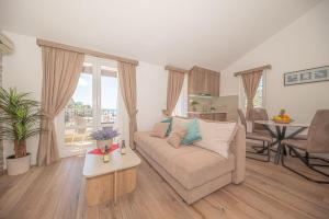 a living room with a couch and a table at Guest House S-Lux in Petrovac na Moru