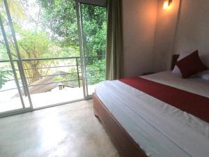 Kandy River Breeze tesisinde bir odada yatak veya yataklar