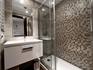 a bathroom with a sink and a glass shower at Frontera Blanca Confort in Pas de la Casa