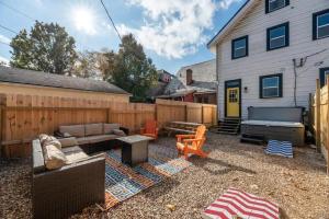 a backyard with a couch and a table and a fence at 5 Bedrooms Sleeps 14 Hot Tub Fire Pit in Columbus