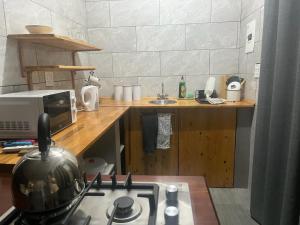 a kitchen with a stove top oven and a microwave at @Eland B&B in Mokopane +4 photos