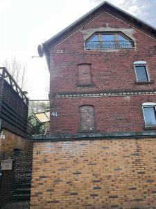 a brick building with windows on top of it at Apartments zum Wildgehege in Siegen