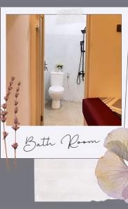 a bathroom with a toilet in a room at Belle's WMR Guest House in Jakarta