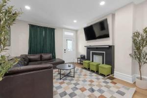 a living room with a couch and a fireplace at 5 Bedrooms Sleeps 14 - Hot Tub - 1 min to Fairgrounds in Columbus