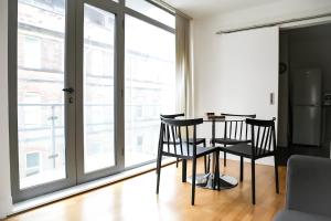 a dining room with two chairs and a table in front of a window at Serviced Apartment In Liverpool City Centre - Free Parking - Balcony - by Happy Days in Liverpool