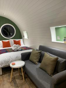 a bedroom with a bed and a couch and a table at Luxury Glamping In North Yorkshire National Park & Coastal Area in Scarborough