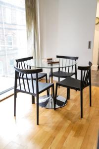 a table and two chairs and a table and a window at Serviced Apartment In Liverpool City Centre - Free Parking - Balcony - by Happy Days in Liverpool