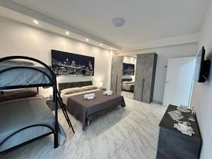a bedroom with a bunk bed and a table in it at Gli Amici della Puglia in Taranto