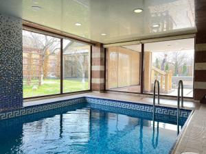 a swimming pool in a house with windows at Villa Nor Hachn, Kotayq in Nor Hachyn