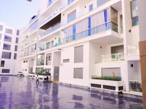 a person walking in the rain in front of a building at AgadirBay in Agadir