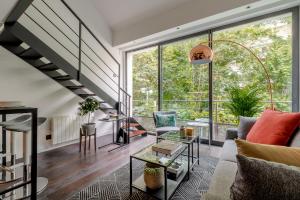 - un salon avec un escalier et de grandes fenêtres dans l'établissement B5 Loft Duplex 175Blo-Paris Convention, à Paris