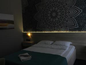 a bedroom with a bed with a black and white wall at Altyn Shatyr Hotel and Restaurant in Aksay
