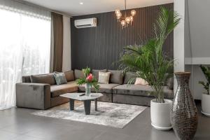 a living room with a couch and a table at Premier Umalas Villas in Seminyak
