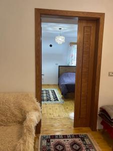 a room with a door leading to a bedroom at Florija’s Guesthouse in Dardhë