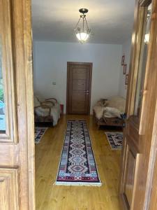 a room with a hallway with a door and a rug at Florija’s Guesthouse in Dardhë