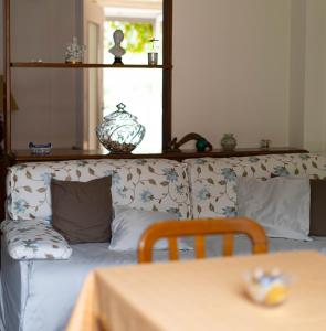 a couch with pillows and a table in a room at Residenza Maria Pia in Turin