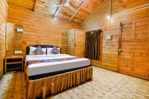 una camera da letto con un letto in una stanza di legno di Via Jesant Valley Resort - Nr Candolim Beach a Candolim